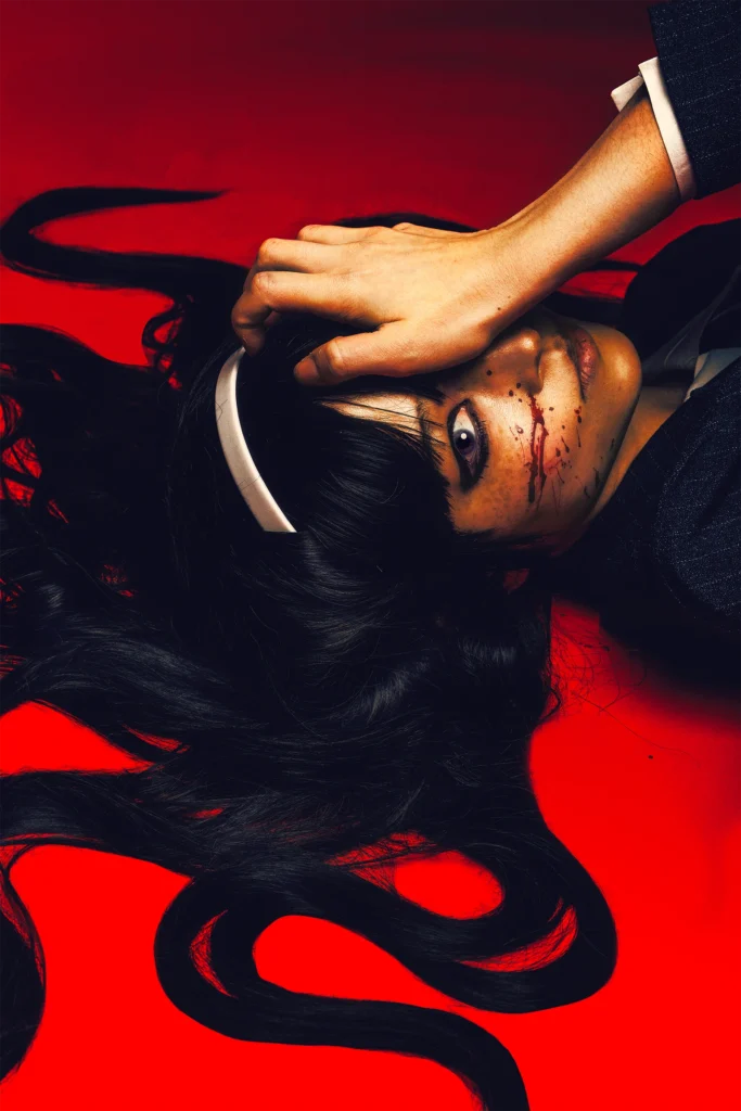 Tomei from Junji Ito cosplay with blood on her cheek on red background by influencer me.bigboy in haunting, horror editorial portrait.