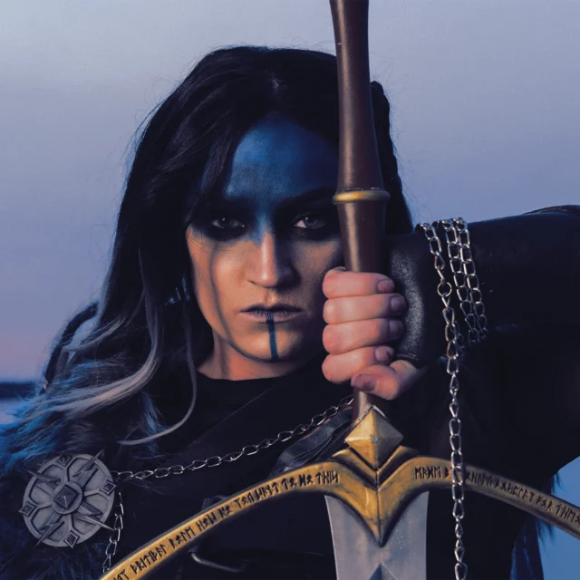 Yasha Ndoorin cosplay by Nora Dahlberg outside Gaylord National during Katsucon holding a sword looking into camera editorial portrait.