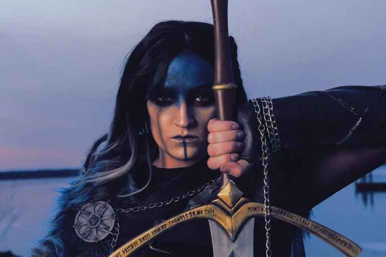 Yasha Ndoorin cosplay by Nora Dahlberg outside Gaylord National during Katsucon holding a sword looking into camera editorial portrait.